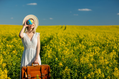 woman-in-dress-with-suitcase-and-earth-globe-in-ra-2024-09-26-10-31-20-utc